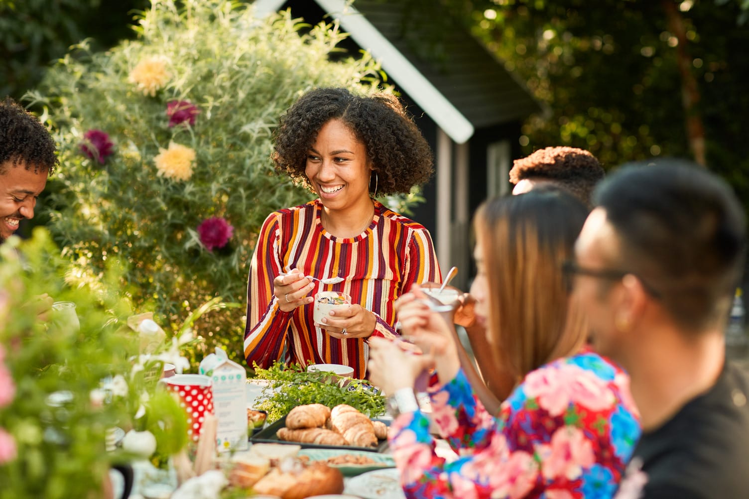 Friends sharing food at an outdoor table
