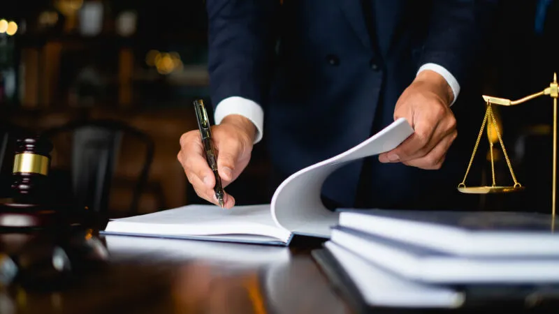 Legal professional reviewing documents at a desk