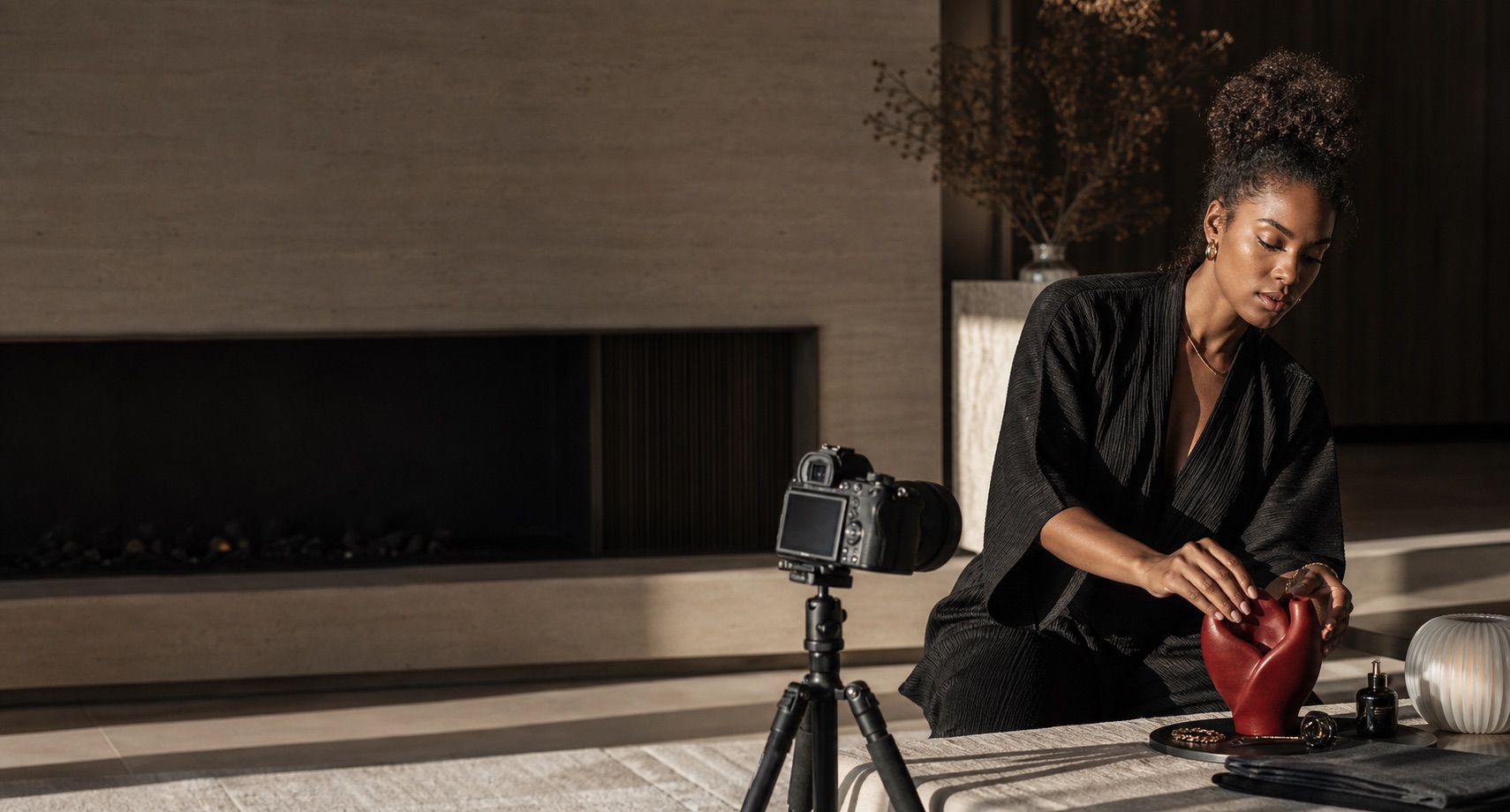 Fashion creator preparing a refined product story in a contemporary suite